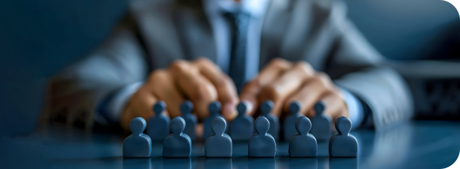 A person in a suit sitting at a table with a group of icons on table replicating people in a business meeting.