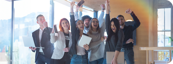 Team memebrs holding their laptops celebrating the success of their project refers to track record of success
